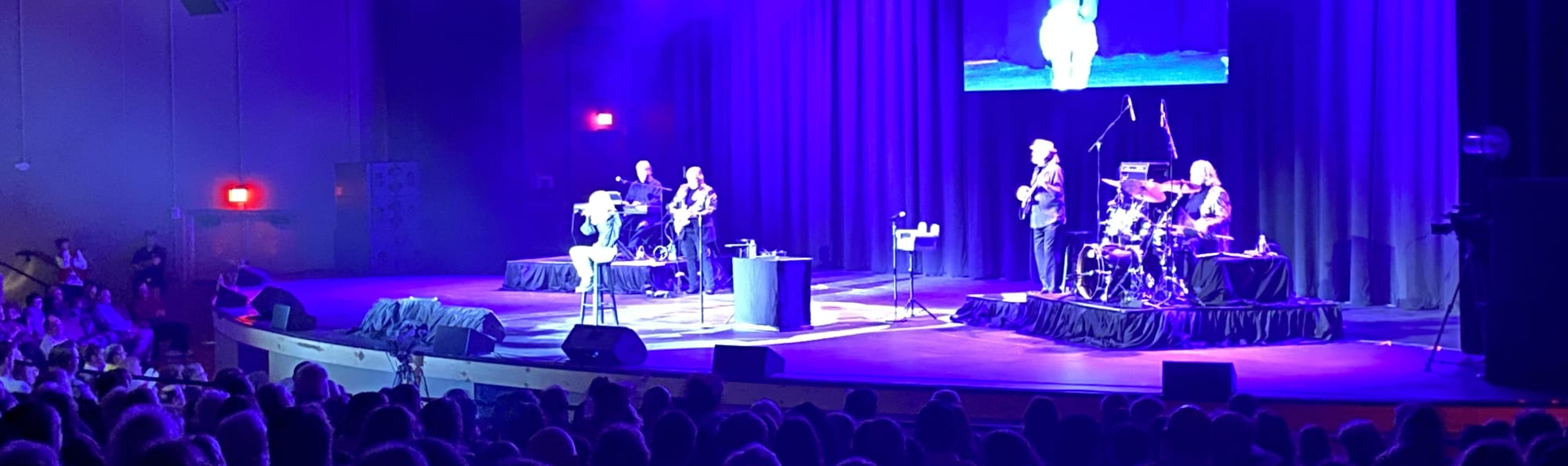 signer on stage in chair washed out by the lights Myrtle Beach